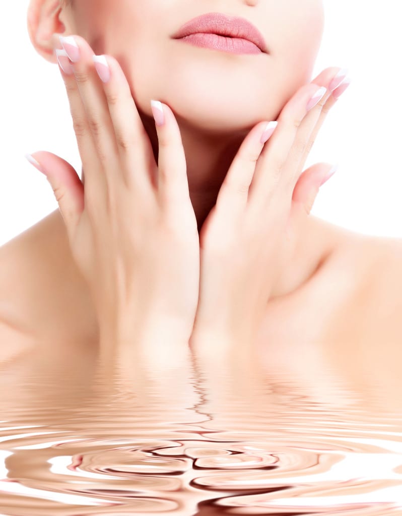 Woman feeling face and reflecting in water